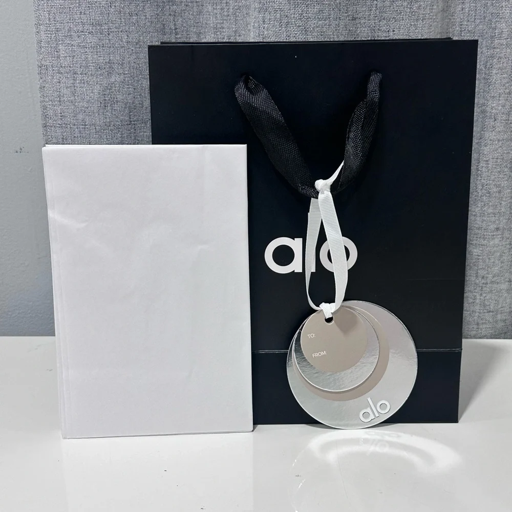 ALO black and white, empty paper bag with tissue paper and holiday gift charm. - Picture 2 of 5